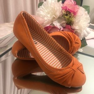 Orange ballet flats with bow detail